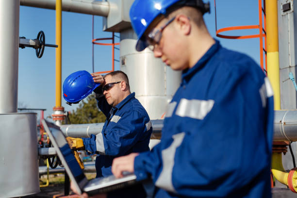 worker in a hard hat on Heavy equipment and pipeline